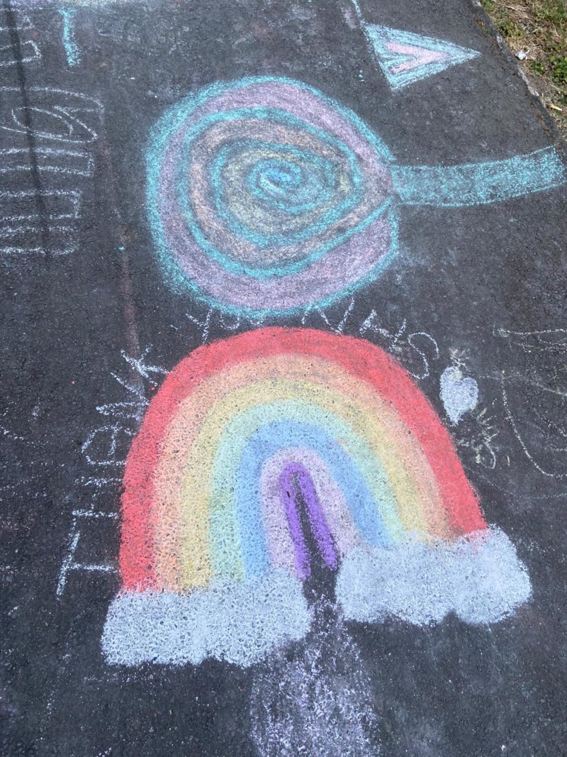 A rainbow with the words "Thank You NHS" chalked onto the pavement