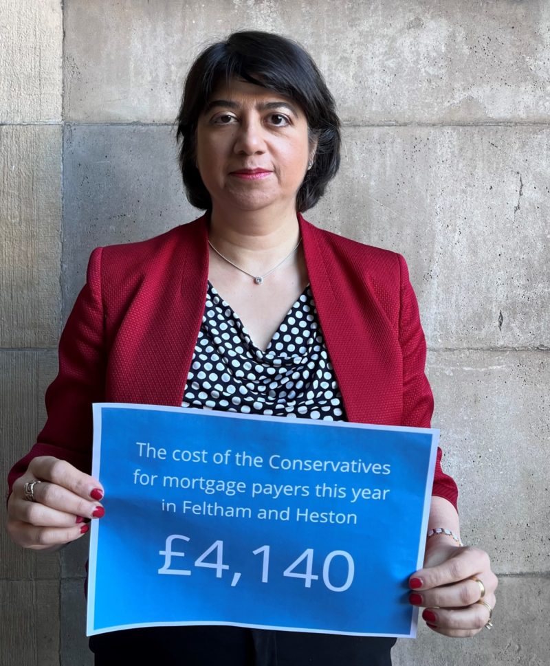 Seema Malhotra holds a sign reading: "The cost of the Conservatives for mortgage payers this year in Feltham and Heston - £4,140"