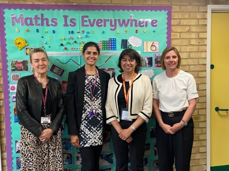 Seema Malhotra MP and Southville staff stand in front of a sign saying "Maths is Everywhere"