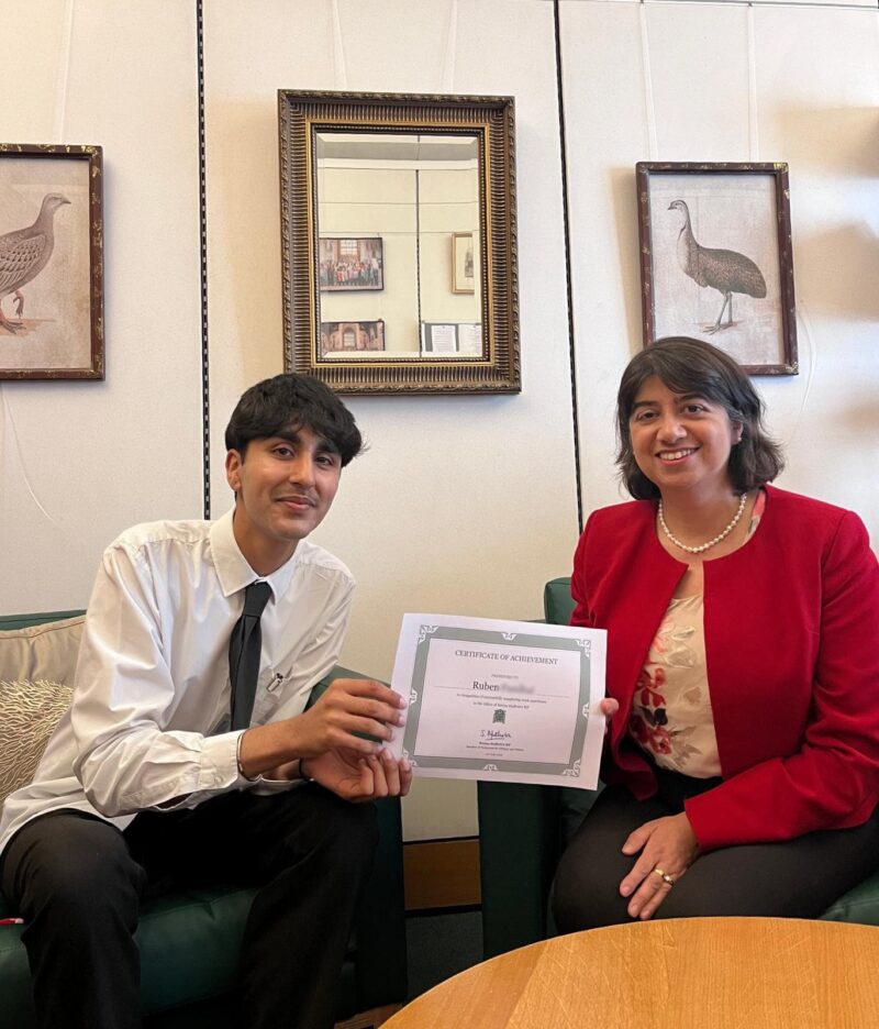 Seema Malhotra with work experience student Ruben, holding a certificate of achievement